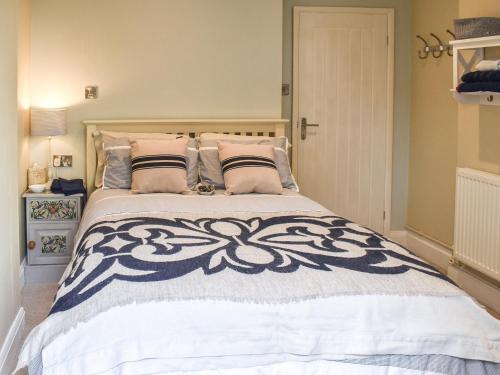 a bedroom with a large bed with pillows at Sam's Snug in Birchington