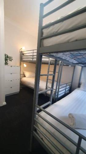 a bedroom with two bunk beds and a dresser at Southern Cross Apartment 1 in Falls Creek