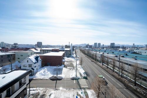 an aerial view of a city with snow covered buildings at E-US Naebo 603 in Sapporo