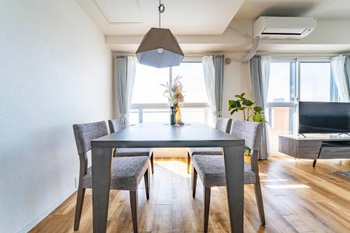 a dining room with a table and chairs at E-US Naebo 603 in Sapporo