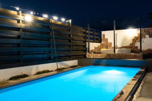 a swimming pool at night with lights on a house at M-STYLE Shirako in Shirako