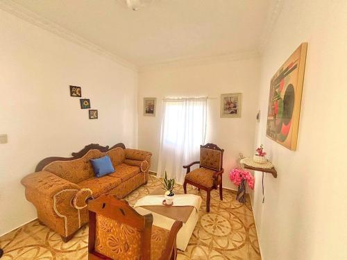a living room with a couch and a table at Villa Rosa 3 Habitaciones Balcones Aire Acondicionado Espacio Ideal Para Tu Familia O Grupo in Río San Juan