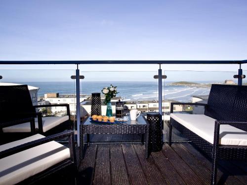 a balcony with a table with a view of the ocean at 42 Ocean 1 in Crantock