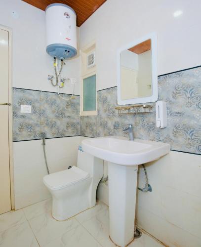 a bathroom with a sink and a toilet at Verma Homestay by Decent stays in Shimla