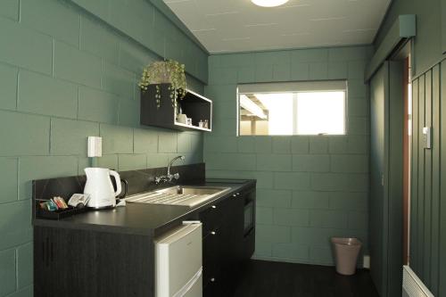 a kitchen with a sink and a counter top at City Close Motel in Napier