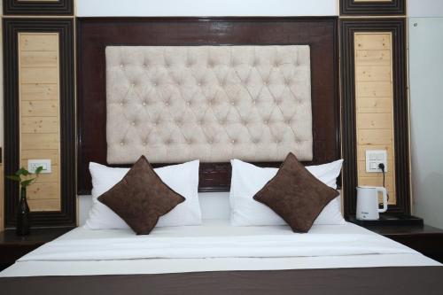 a bedroom with a large bed with white sheets and pillows at Verma Homestay by Decent stays in Shimla