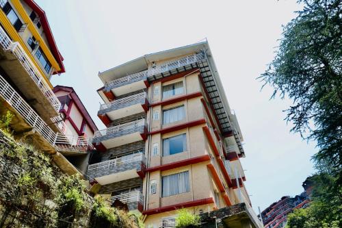 a tall building with balconies on the side of it at Verma Homestay by Decent stays in Shimla