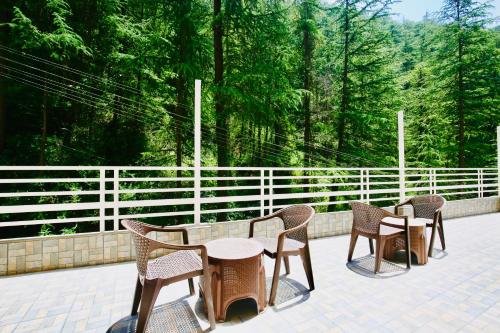 a group of chairs and tables on a patio at Nature Retreat new shimla #city centre #near to mall road #private parking #Balcony view in Shimla