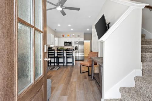 a kitchen and living room with a ceiling fan at Whole Home 1012 & 1014 Franklin in Clarksville