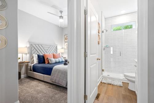 a bedroom with a bed and a bathroom at Whole Home 1012 & 1014 Franklin in Clarksville