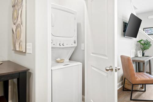 a white laundry room with a washer and dryer at Whole Home 1012 & 1014 Franklin in Clarksville