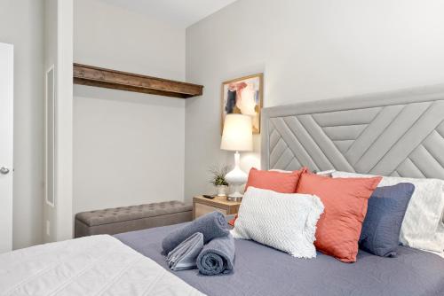 a bedroom with a bed with colorful pillows on it at Whole Home 1012 & 1014 Franklin in Clarksville