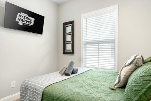 a bedroom with a bed and a window at Whole Home 1012 & 1014 Franklin in Clarksville