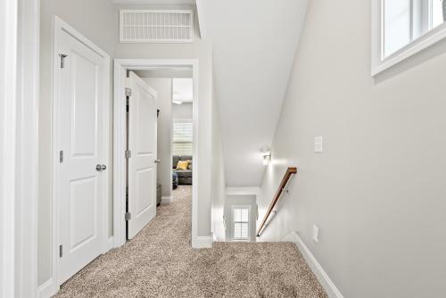 a hallway with white walls and white doors at Whole Home 1012 & 1014 Franklin in Clarksville