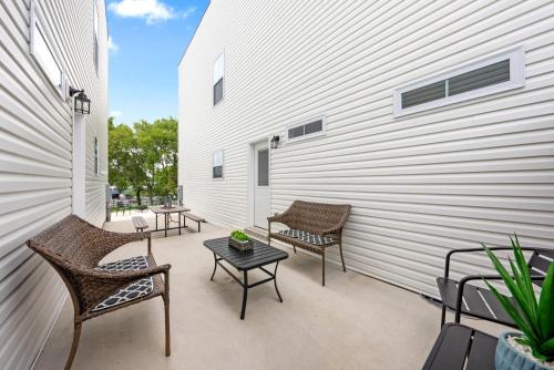 a patio with two chairs and a table on a building at Whole Home 1012 & 1014 Franklin in Clarksville