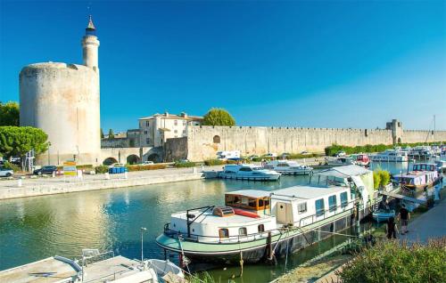 a group of boats docked in a harbor next to a castle at 3 Bedroom Amazing Home In Sorgues in Sorgues