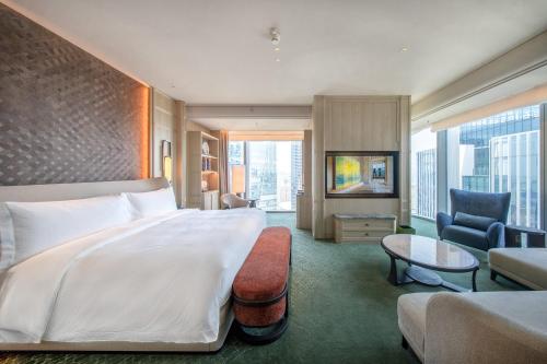 a hotel room with a large bed and a couch at The St. Regis Shenzhen Bao'an in Shenzhen