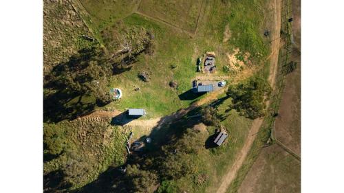 an aerial view of a house in a field at Clover at Lexington Park by Tiny Away in Tarlo
