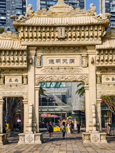an archway in a city with people walking through it at 佛山顺德青森酒店-长鹿旅游休博园店 in Shunde