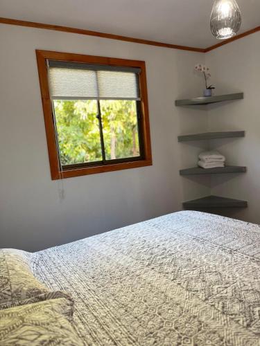 a bedroom with a bed and a window at Entre Ríos, Santa Cruz 
