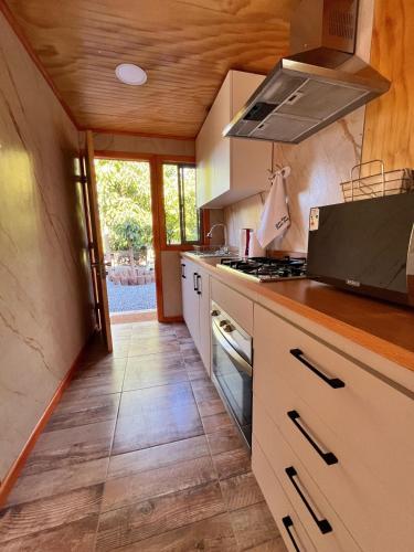 a kitchen with white cabinets and a stove top oven at Entre Ríos, Santa Cruz 