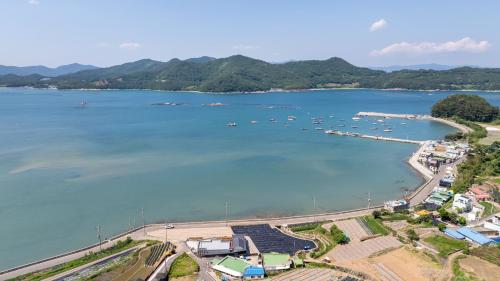 an aerial view of a harbor with boats in the water at Namhae Andante Pension in Namhae