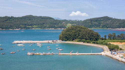 an aerial view of a harbor with boats in the water at Namhae Andante Pension in Namhae