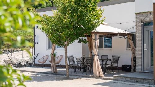 a patio with a table and chairs under a canopy at Namhae Andante Pension in Namhae