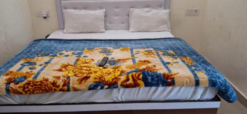 a bed with a comforter with bananas on it at Hotel New Residency Ayodhya in Ayodhya