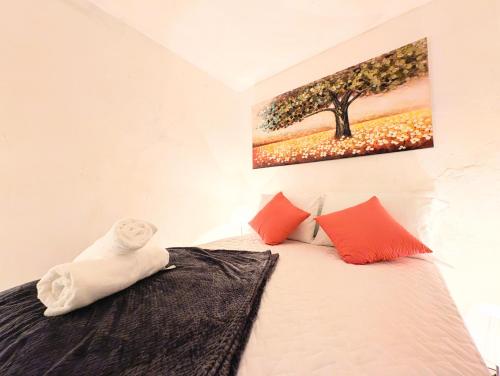 a bedroom with a bed with a painting on the wall at Casa Gardenia in Guatemala
