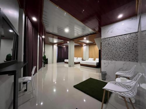 a living room with white chairs and a couch at Serenity Villa Guci in Tuwel