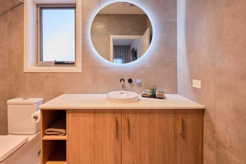 a bathroom with a sink and a mirror at BIG4 Launceston Holiday Park in Launceston