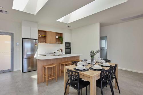 a kitchen with a wooden table and chairs in a kitchen at BIG4 Launceston Holiday Park in Launceston