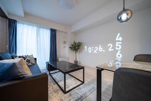 a living room with a couch and a table at MD302 Super rare location! 2bedroom!Home Theater! in Sapporo