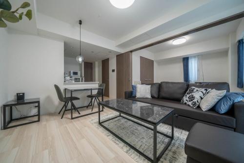 a living room with a couch and a table at MD302 Super rare location! 2bedroom!Home Theater! in Sapporo