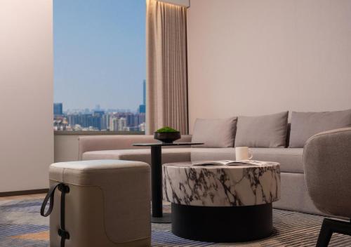 a living room with a couch and a table at Holiday Inn Express Wuhan Jianghan Road by IHG in Wuhan