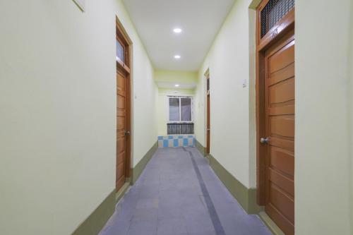 an empty corridor with two doors at SPOT ON SR CONTINENTAL in Hyderabad