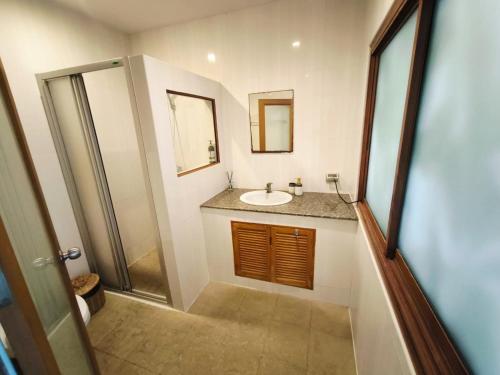 a bathroom with a sink and a mirror at Grand appartement vue mer, Sunset!!! in Amphoe Koh Samui