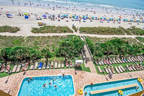 an aerial view of a beach with two swimming pools and people at Anderson Ocean Club and Spa by Oceana Resorts in Myrtle Beach