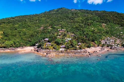 an island in the ocean with houses on it at Manja Kely Lodge in Nosy Be