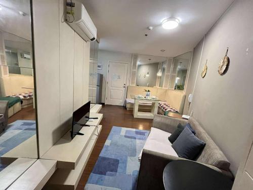 a living room with a couch and a table at Gramercy Makati Condotel in Manila