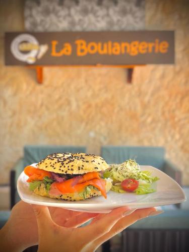 a person holding a plate with a sandwich on it at Mayafair All Inclusive in Cancún