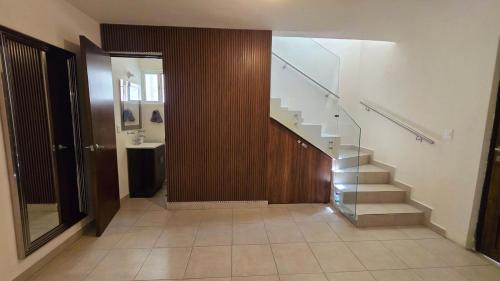 a hallway with a staircase in a house at Modern and Centrally Located House in Monterrey