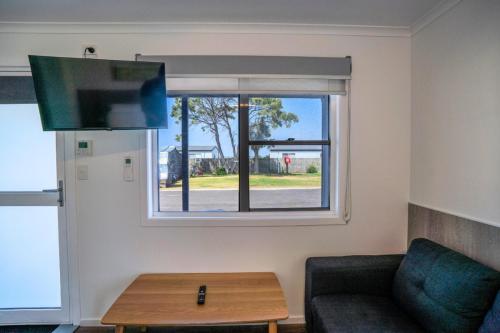 a living room with a couch and a window at BIG4 Tassie Getaway Park Stanley in Stanley