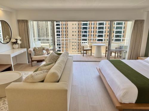 a bedroom with a large bed and a living room at Panoramic Oceanview Resort - Full Kitchen in Each Unit, 2 Swimming Pools, Onsite Restaurants, Fireworks Every Friday in Honolulu