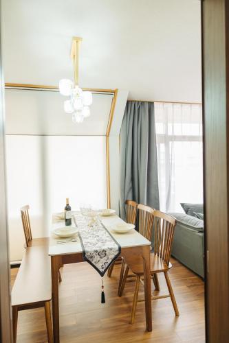 a dining room with a table and chairs and a bed at X103Nagoya Station area courtyard rental detached house in Nagoya