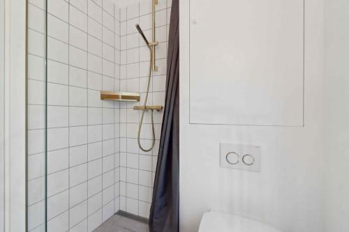 a bathroom with a shower with a toilet and a shower curtain at New House Near Asserbo Plantation And Arresø in Frederiksværk