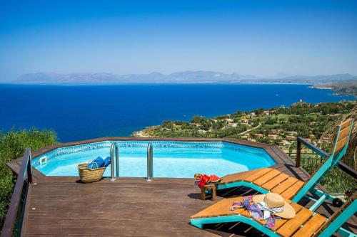 a swimming pool with a view of the water at Palma Dello Zingaro in Scopello