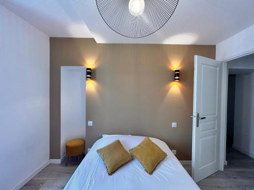 a bedroom with a bed with two pillows on it at Rebeca - 4 pers Standing - Hyper centre -Terrasse in Saint-Raphaël