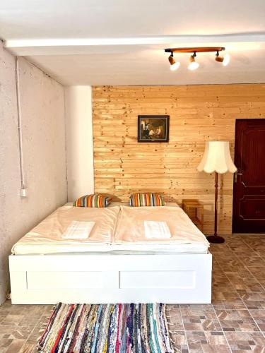a bed in a room with a wooden wall at Appartment Susi 